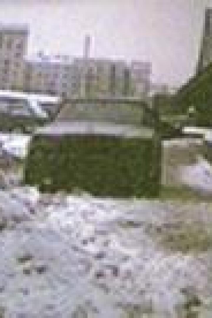 Ein Auto fährt durch eine verschneite Straße in einer Stadt.