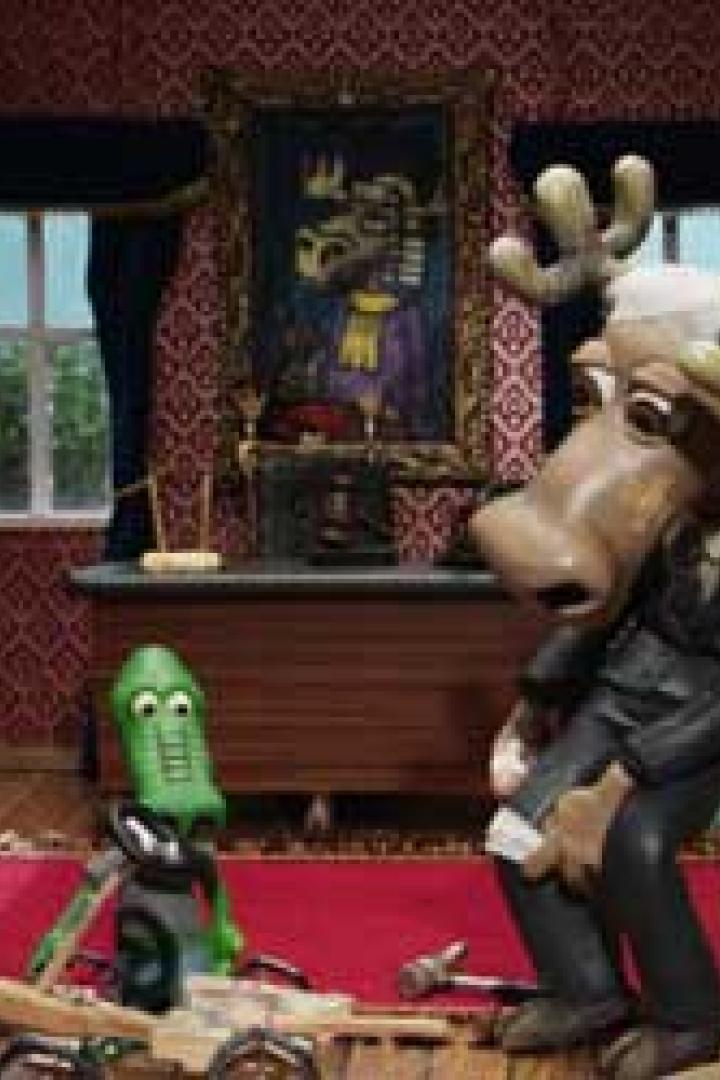 Eine animierte Szene mit einem Elch in einem Anzug und einer grünen Figur in einem Raum.