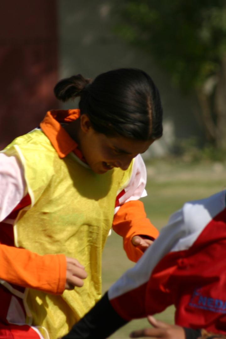 Lächelnde junge Frauen in Sportkleidung laufen im Freien.
