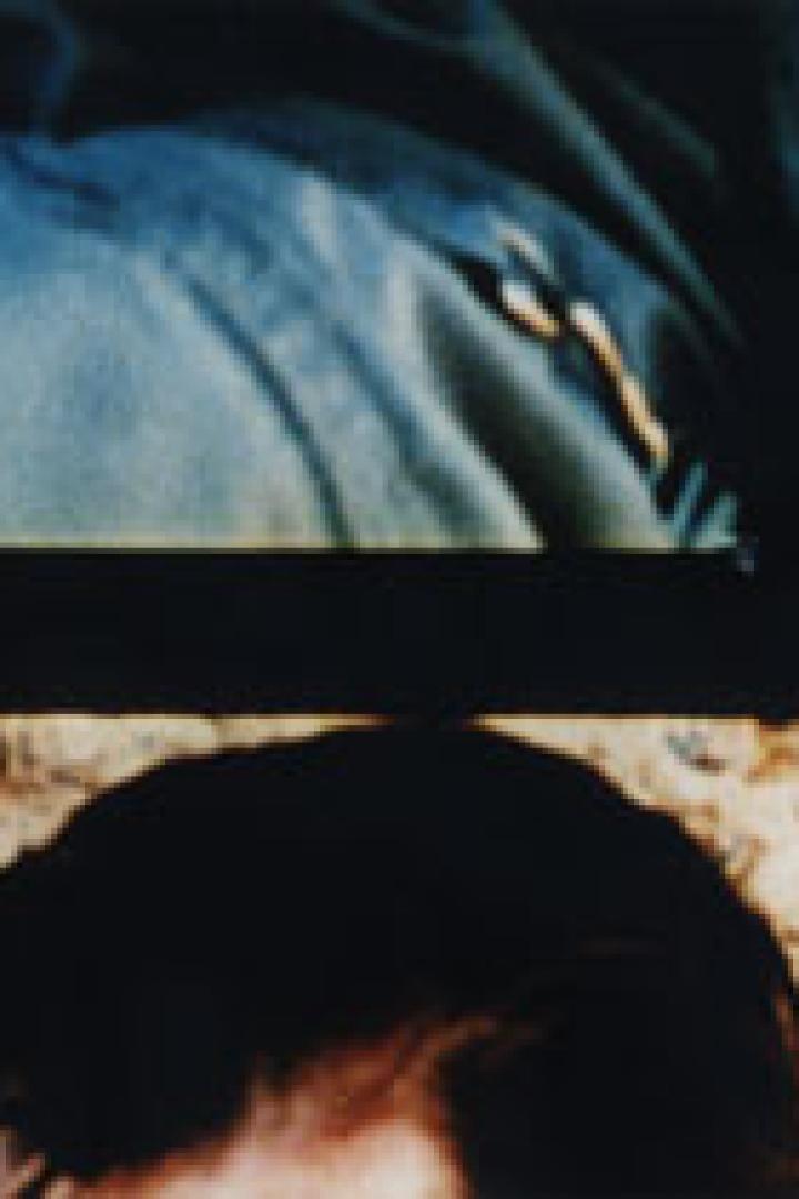 Nahaufnahme des Gesichts einer Person unter einem blauen Stoff.