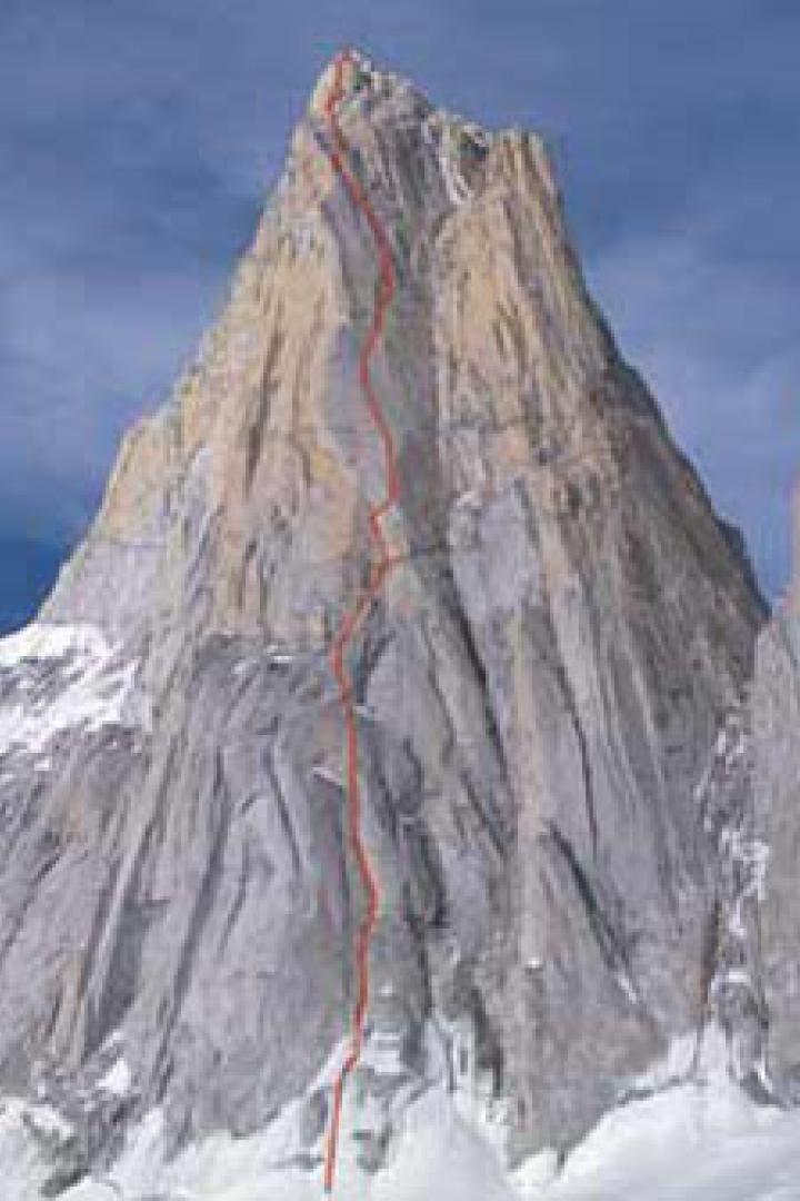 Ein hoher, felsiger Berg mit einer rot markierten Kletterroute.