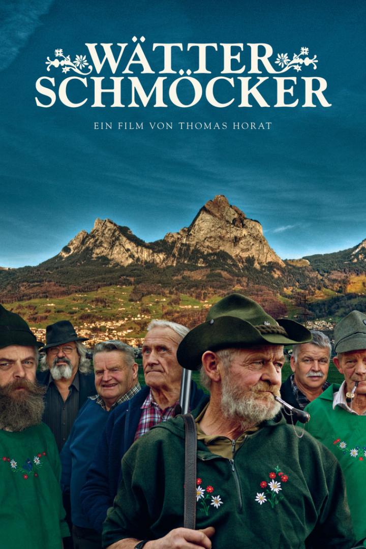 Das Filmplakat für „Wätter Schmöcker“ zeigt eine Gruppe älterer Männer vor einer Bergkulisse.