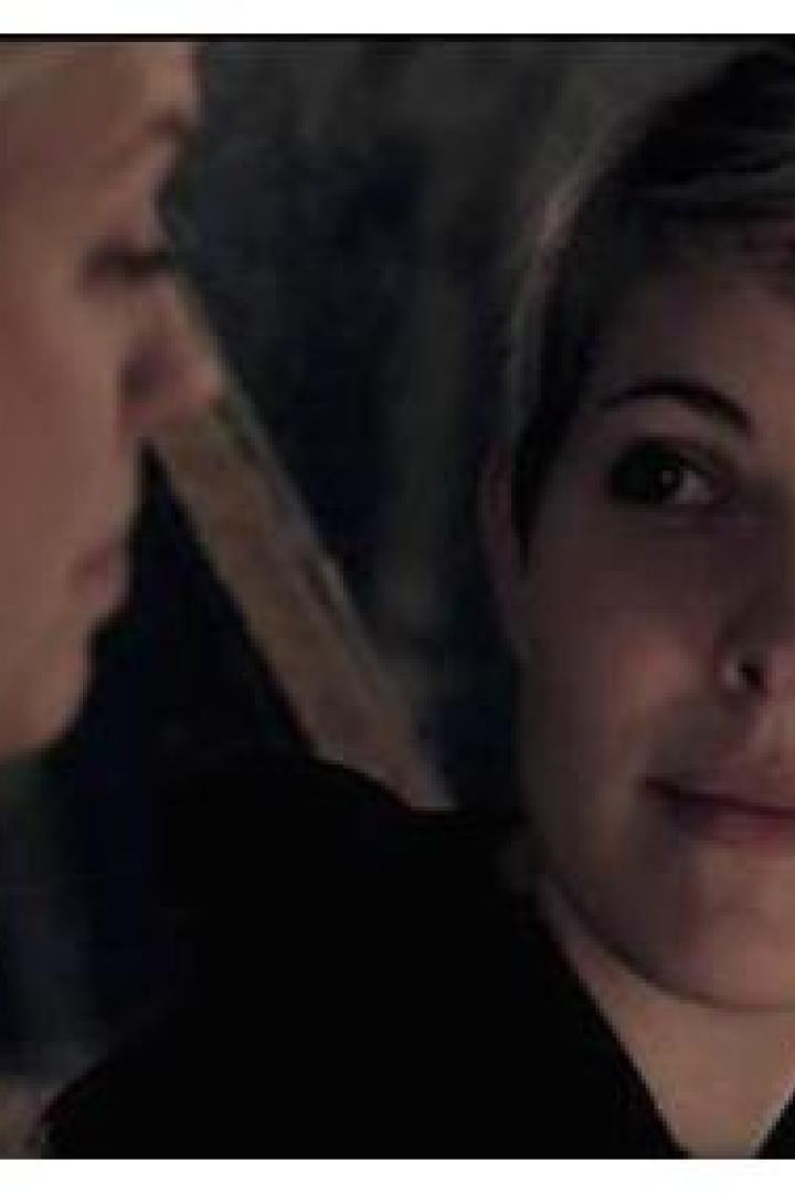 Eine Frau mit kurzen blonden Haaren schaut eine andere Frau an.