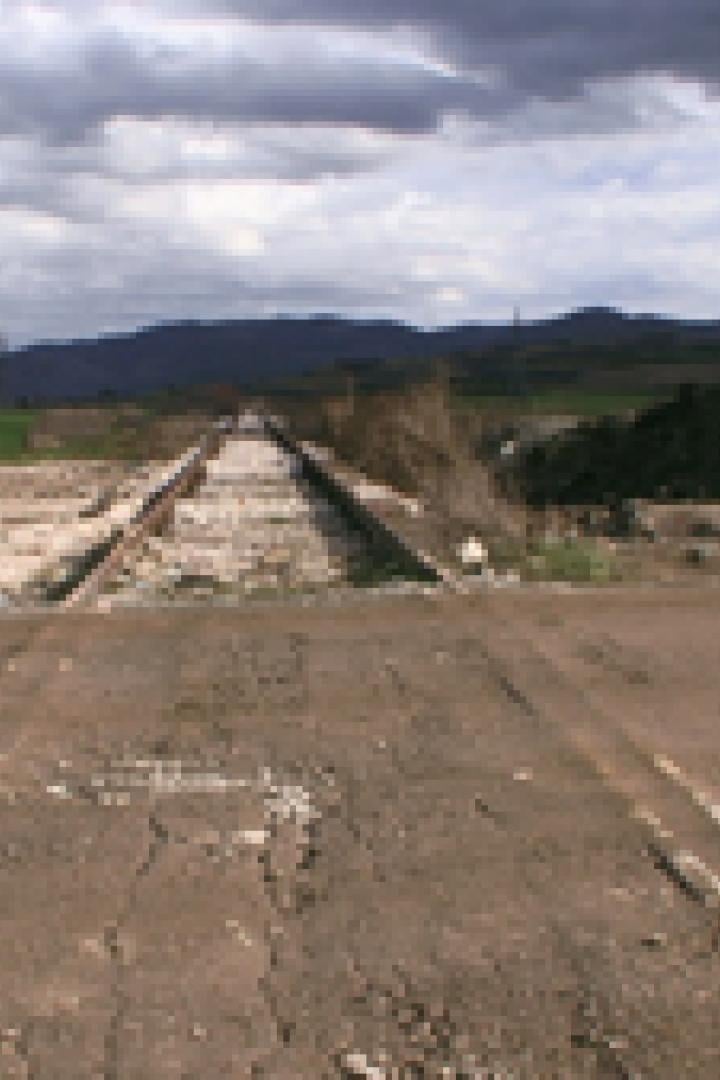Eine stillgelegte Eisenbahnstrecke führt durch eine ländliche Gegend.