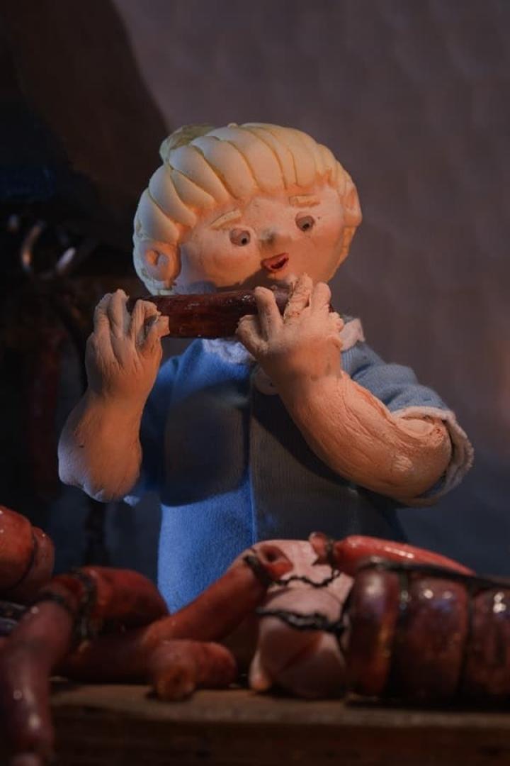 Eine Knetfiguren-Szene zeigt ein Kind, das eine Wurst isst, umgeben von weiteren Würsten.