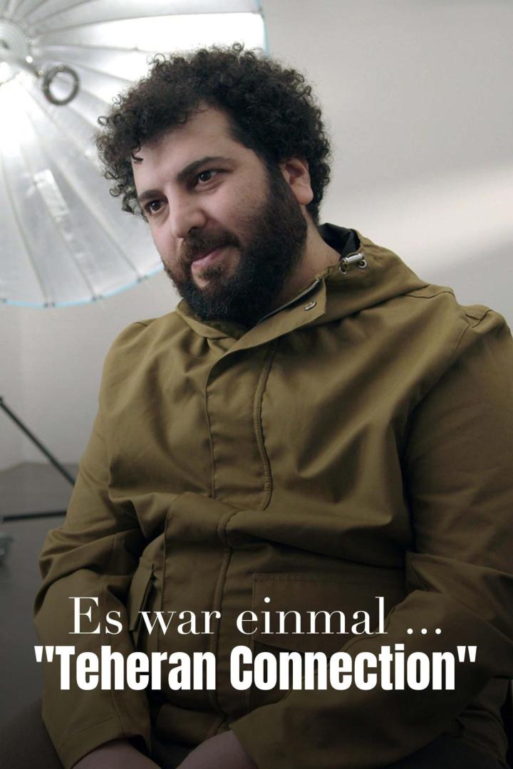 Ein Mann mit Bart und lockigem Haar vor einem Studiolicht, möglicherweise im Zusammenhang mit „Teheran Connection“.