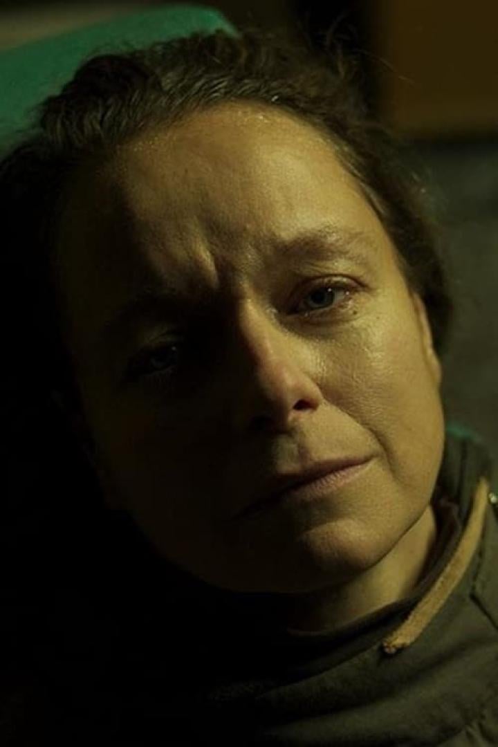 Nahaufnahme des Gesichts einer Frau mit ernstem Ausdruck.