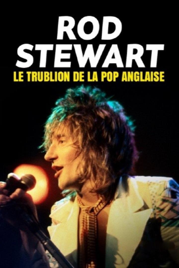 Rod Stewart singt in einem weißen Anzug mit Krawatte in ein Mikrofon.