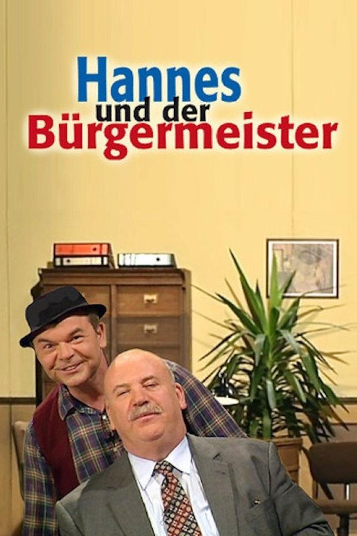 Das Filmplakat für „Hannes und der Bürgermeister“ zeigt zwei Männer vor einem gelben Hintergrund.