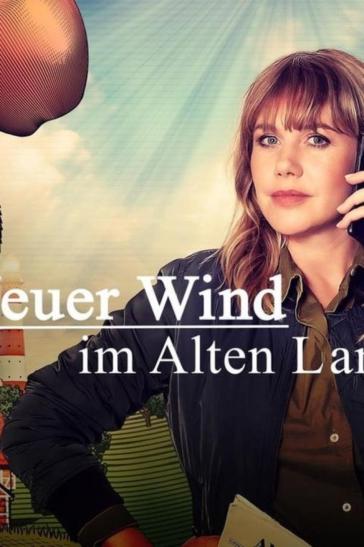 Eine Frau telefoniert vor dem Hintergrund des Titelbilds „Feuer Wind im Alten Land“.