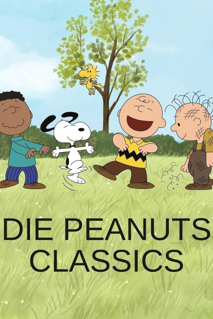 Die Peanuts-Charaktere tanzen auf einer Wiese vor einem Baum, auf dem Woodstock sitzt.