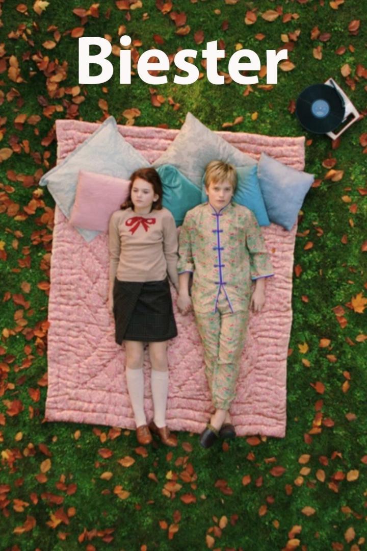 Ein Junge und ein Mädchen liegen auf einer Decke im Grünen, daneben ein Plattenspieler.