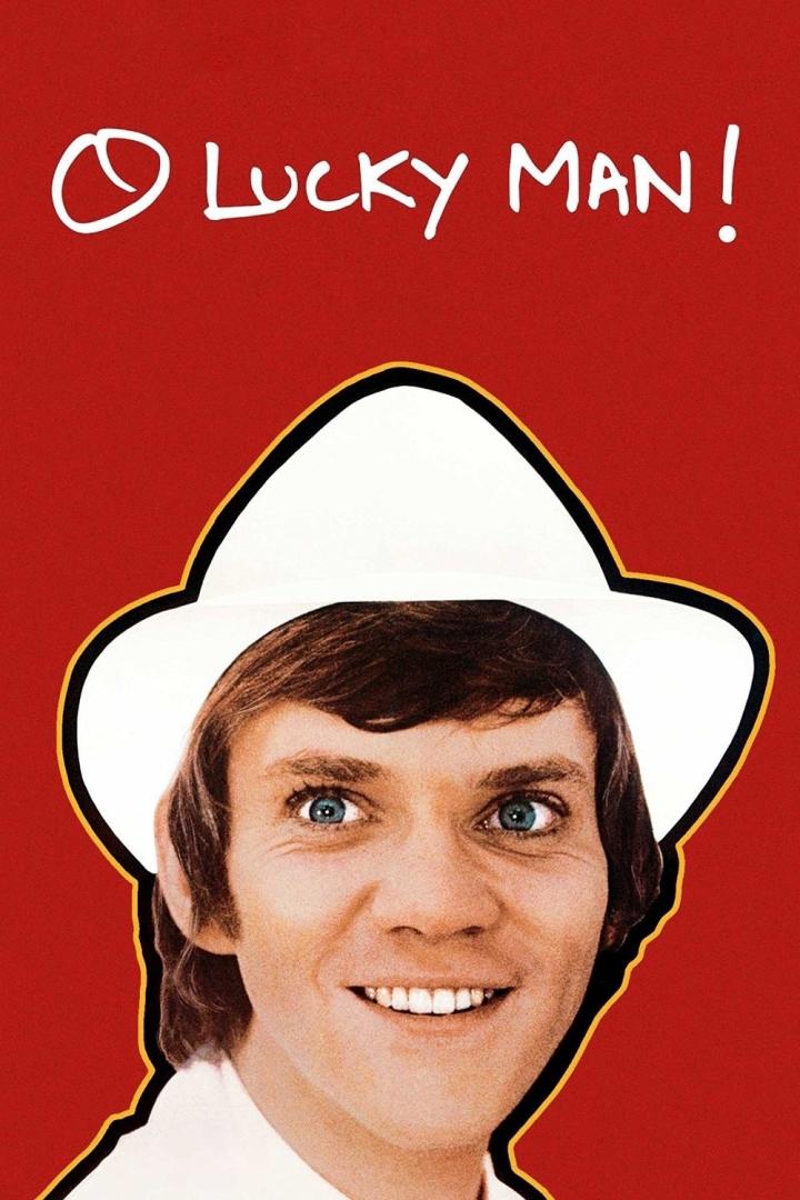 Das Filmplakat für „O Lucky Man!“ zeigt Malcolm McDowell mit Hut vor rotem Hintergrund.