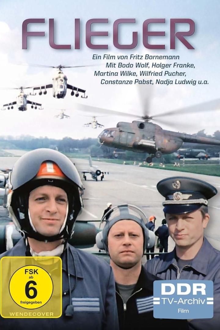 Das Filmplakat für „Flieger“ zeigt Hubschrauber und Piloten auf einem Flugfeld.