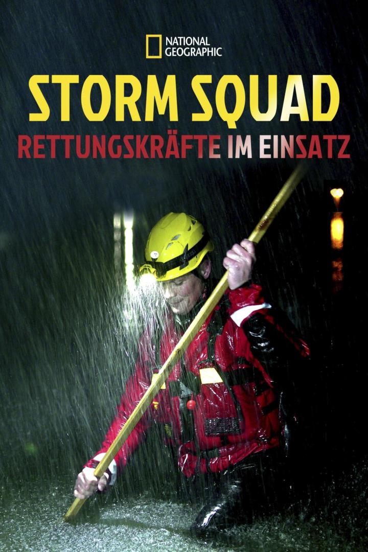 Ein Mitglied des „Storm Squad“ watet im Regen mit einem Stab durch das Wasser.