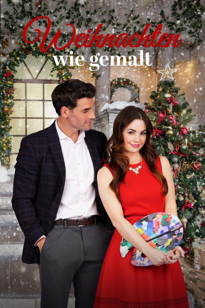 Ein Mann und eine Frau vor einem Weihnachtsbaum, sie hält eine Farbpalette in der Hand.