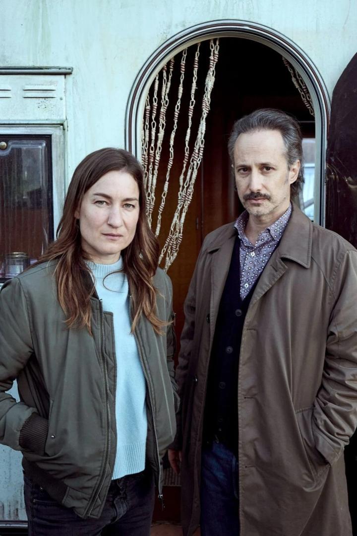 Eine Frau und ein Mann stehen vor einem Wohnwagen.