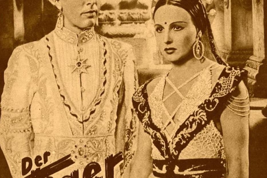 Ein Filmposter für „Der Tiger von Eschnapur“ mit einem Mann und einer Frau in traditioneller indischer Kleidung.