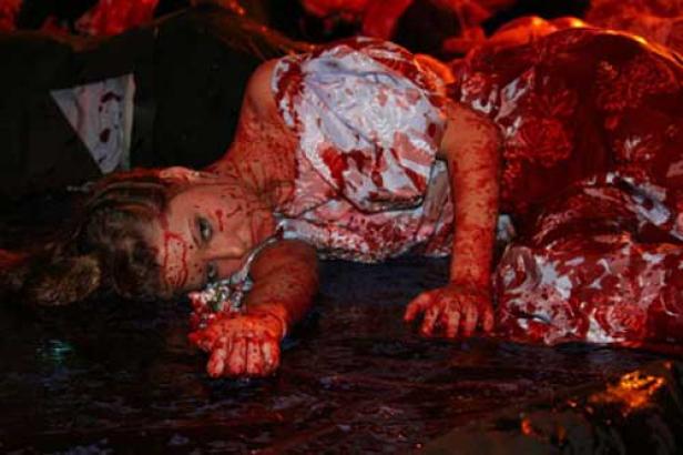 Eine Frau liegt blutverschmiert am Boden.