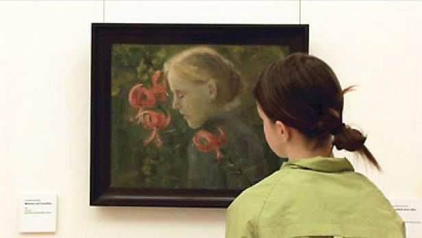 Eine Frau betrachtet ein Gemälde von einem Mädchen mit roten Lilien.