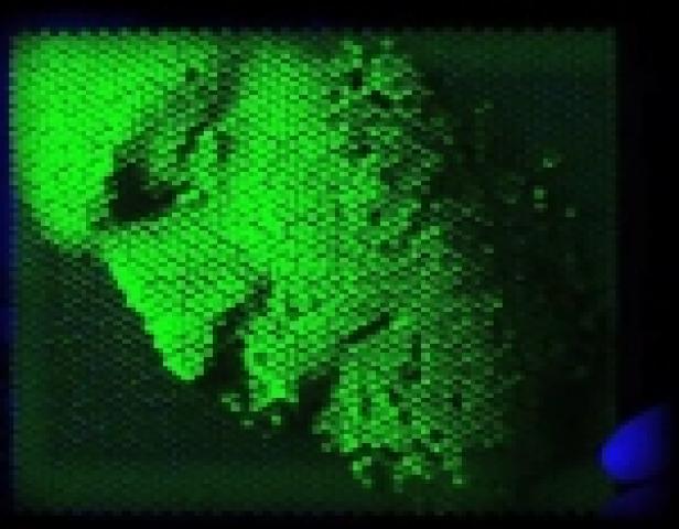 Eine abstrakte Darstellung in Grüntönen mit einem wabenartigen Muster.