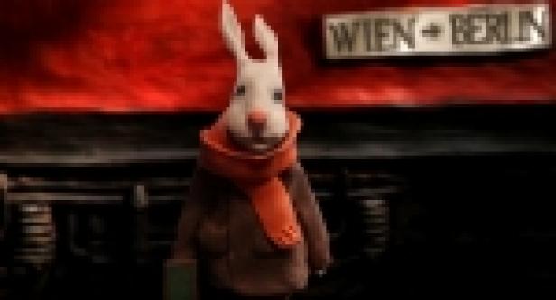 Ein animierter Hase mit Schal steht vor einem Zug nach Wien und Berlin.