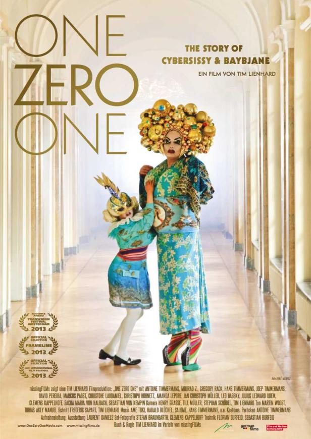 Das Filmplakat zu „One Zero One“ zeigt zwei extravagante Figuren in einem hellen Gang.