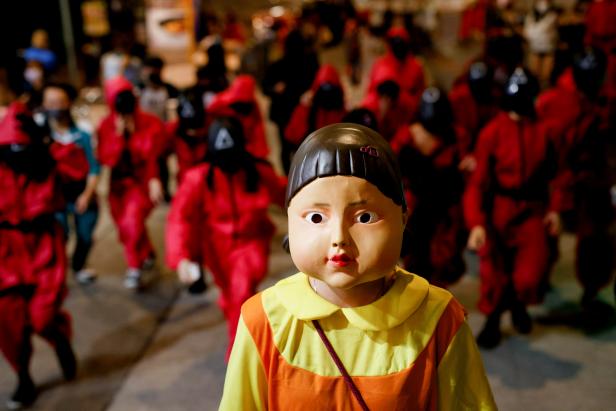 People wear Netflix series 'Squid Game' costumes celebrating Halloween, in Hong Kong