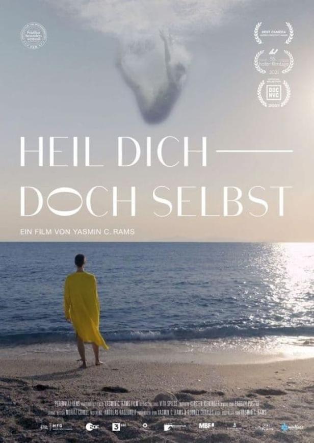 Das Filmplakat für „Heil dich doch selbst“ zeigt eine Person am Strand, die aufs Meer blickt.