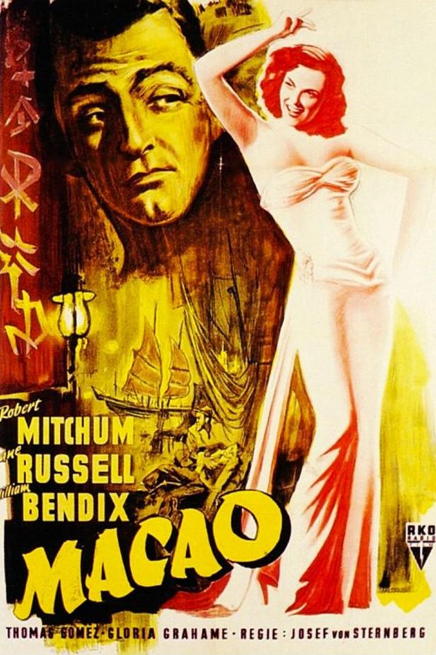 Das Filmplakat für „Macao“ zeigt Robert Mitchum und eine Frau im Abendkleid.