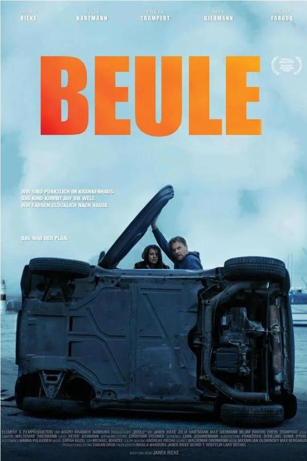 Das Filmplakat für „Beule“ zeigt ein auf dem Dach liegendes Auto mit zwei Personen darin.