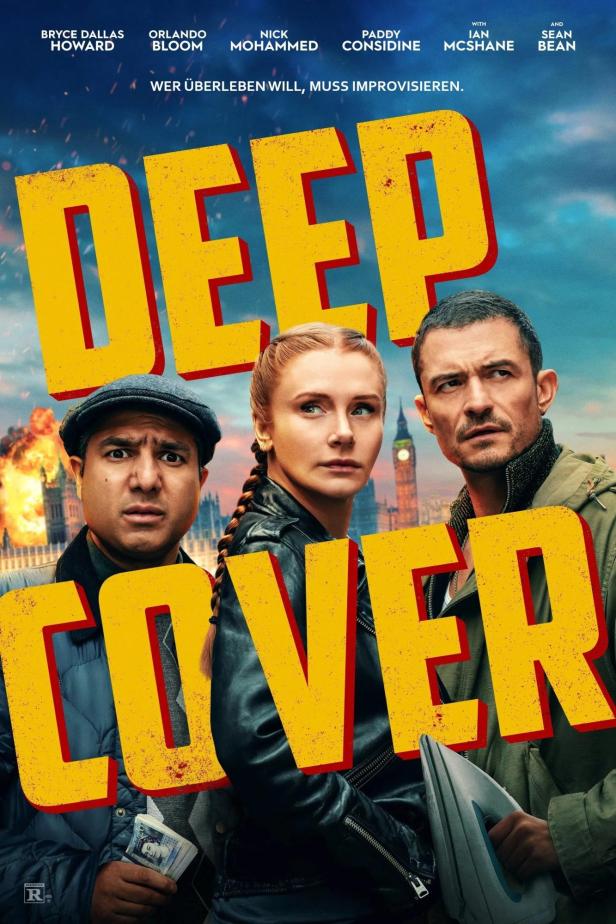 Das Filmplakat zu „Deep Cover“ zeigt Bryce Dallas Howard, Orlando Bloom und Nick Mohammed vor Londoner Wahrzeichen.