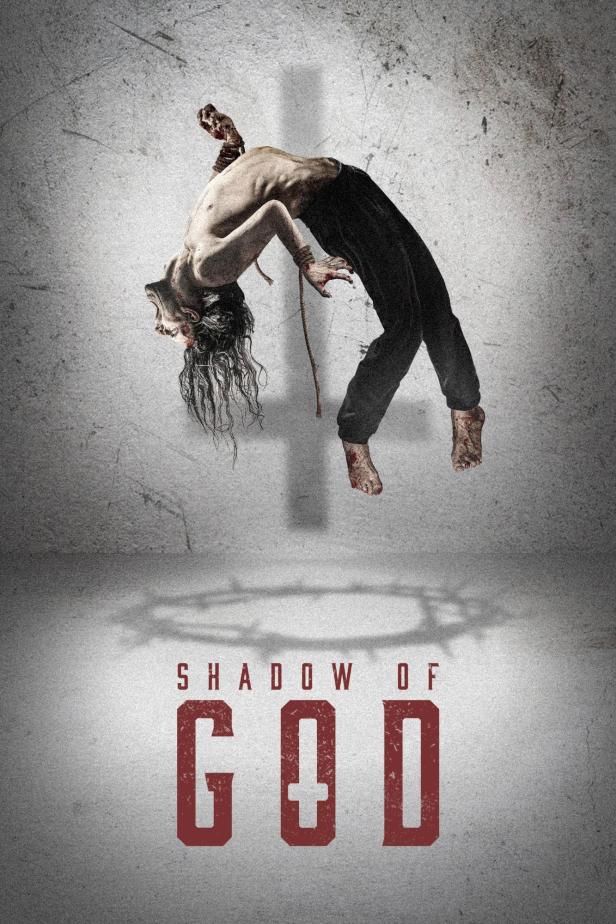Ein Mann hängt kopfüber an einem Seil, im Hintergrund der Titel „Shadow of God“.