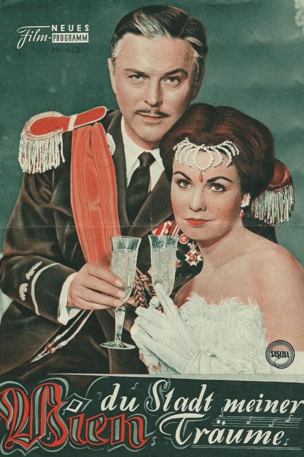 Ein Filmposter für „Wien, du Stadt meiner Träume“ mit einem Paar, das mit Sekt anstößt.