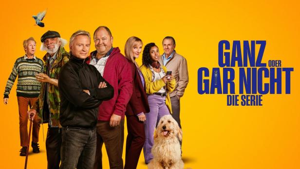 Das Ensemble der Serie „Ganz oder gar nicht“ vor einem gelben Hintergrund.