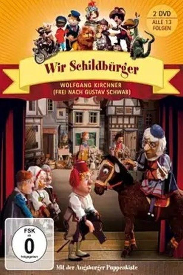 Das DVD-Cover von „Wir Schildbürger“ zeigt Puppenfiguren vor einer Bühnenkulisse.