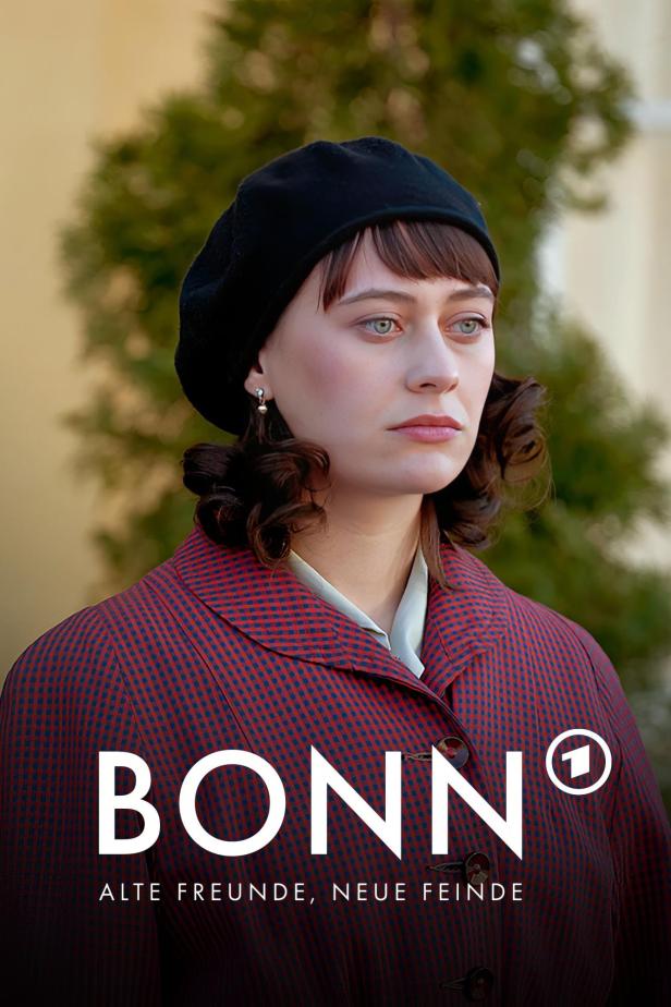 Eine junge Frau mit Baskenmütze und kariertem Mantel, möglicherweise eine Szene aus der Serie „Bonn – Alte Freunde, neue Feinde“.