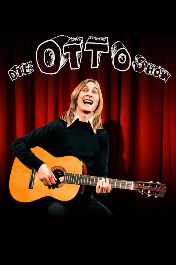 Otto Waalkes spielt Gitarre vor einem roten Bühnenvorhang mit dem Schriftzug „Die Otto Show“.