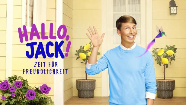 Ein Mann winkt vor dem Hintergrund der Aufschrift „Hallo, Jack! Zeit für Freundlichkeit“.