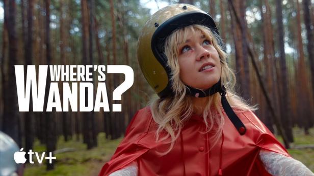 Eine Frau mit Helm und rotem Cape im Wald, im Hintergrund der Titel „Where's Wanda?“.