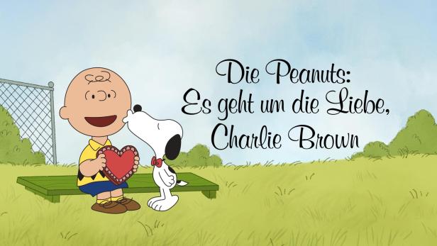 Charlie Brown hält ein rotes Herz, während Snoopy auf einer Bank steht.