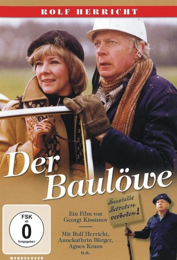 Das Filmplakat zu „Der Baulöwe“ zeigt Rolf Herricht mit Bauhelm und eine Frau mit Hut.