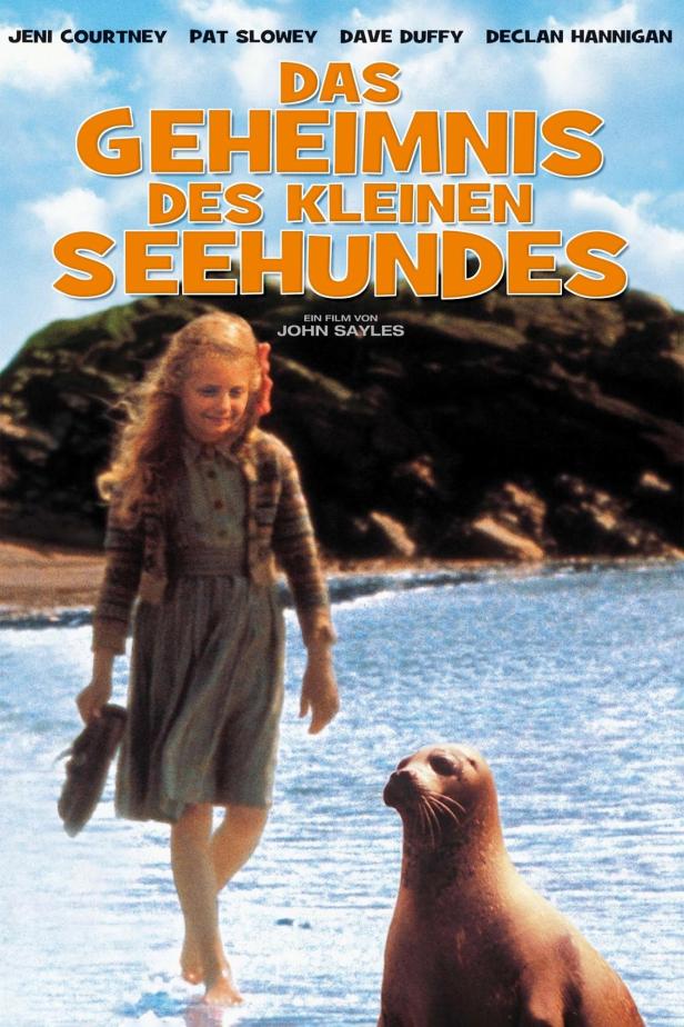 Das Filmplakat für „Das Geheimnis des kleinen Seehundes“ mit Jeni Courtney und einem Seehund am Strand.
