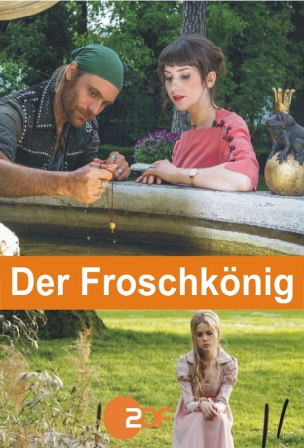 Das Filmplakat für „Der Froschkönig“ zeigt zwei Schauspieler am Brunnen und eine junge Frau im Gras.