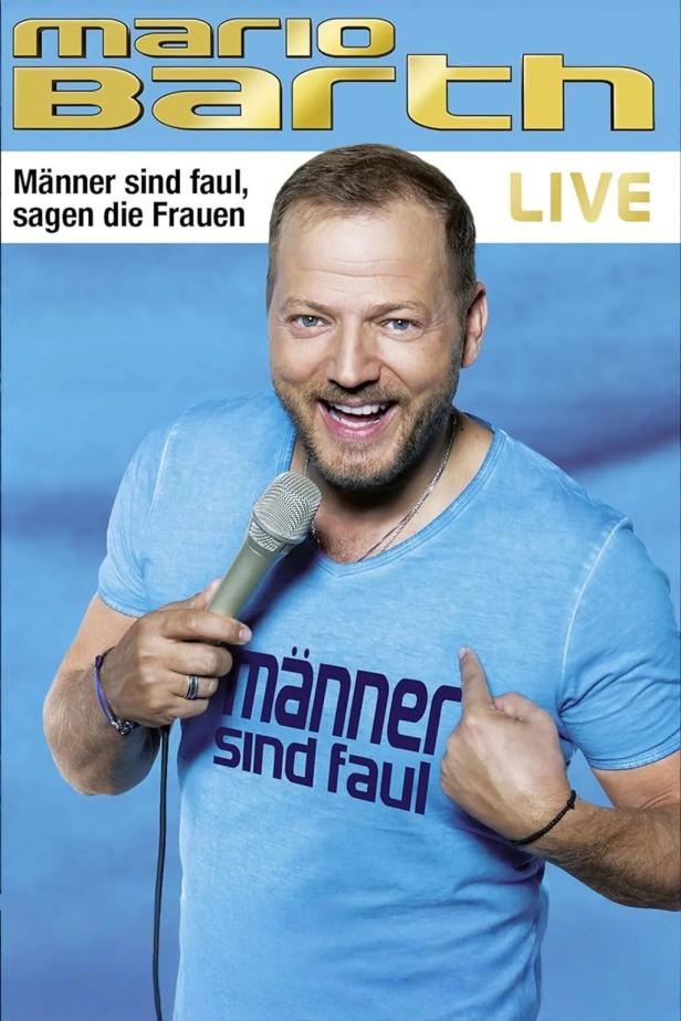 Mario Barth mit Mikrofon, auf seinem T-Shirt steht „Männer sind faul“.