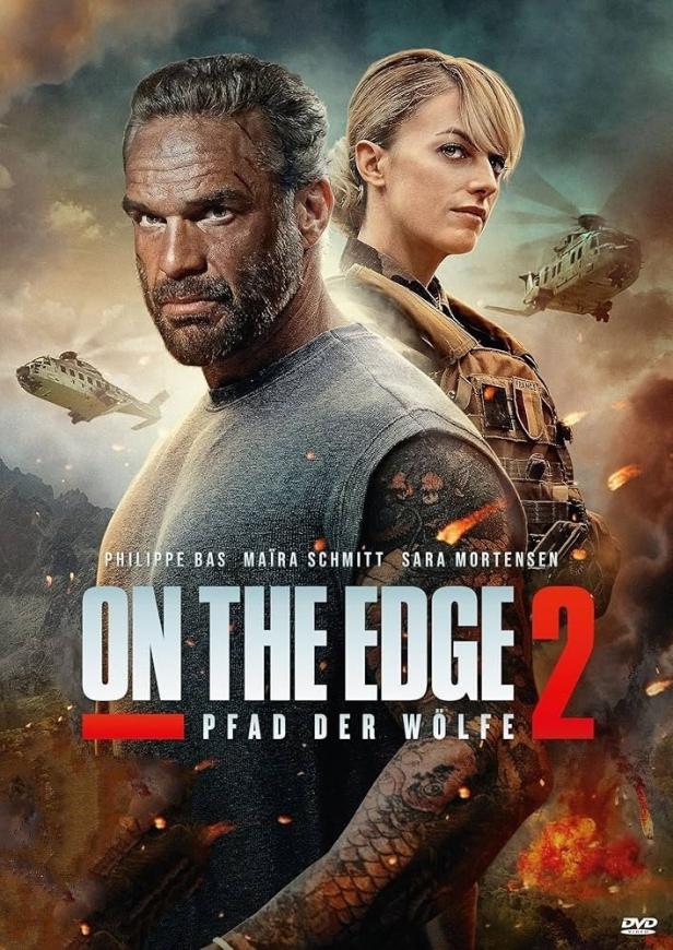 Das Filmplakat für „On the Edge 2 – Pfad der Wölfe“ zeigt zwei bewaffnete Personen und Hubschrauber.