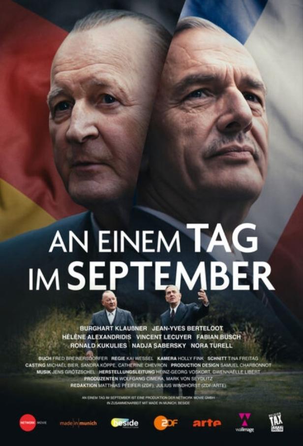 Das Filmplakat für „An einem Tag im September“ zeigt die Gesichter zweier Männer vor deutschen und französischen Flaggen.