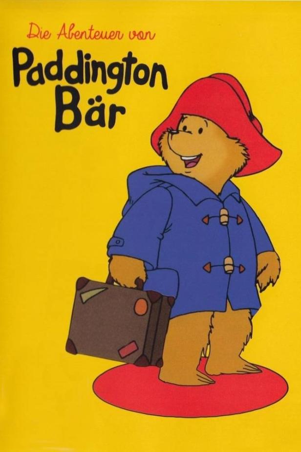 Eine Illustration von Paddington Bär mit Koffer, Hut und blauem Dufflecoat.