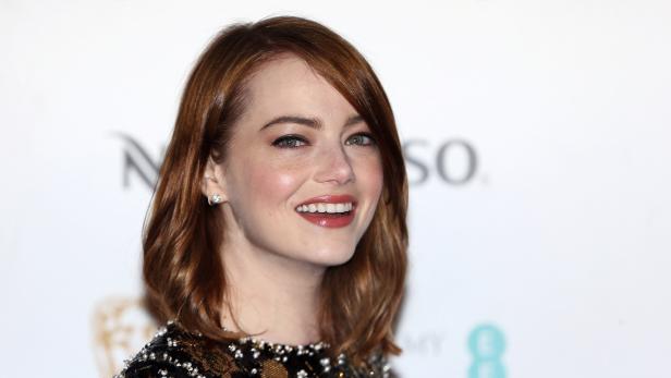 Actress Emma Stone poses for photographers at the