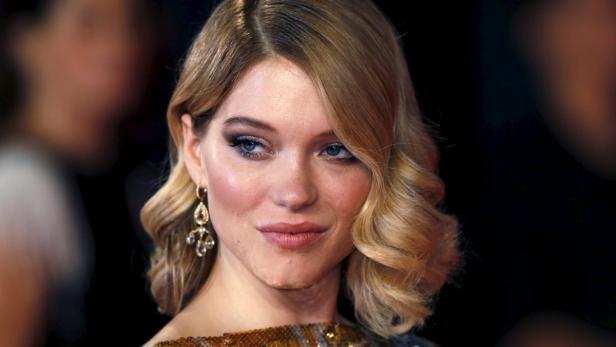 Lea Seydoux poses for photographers on the red car